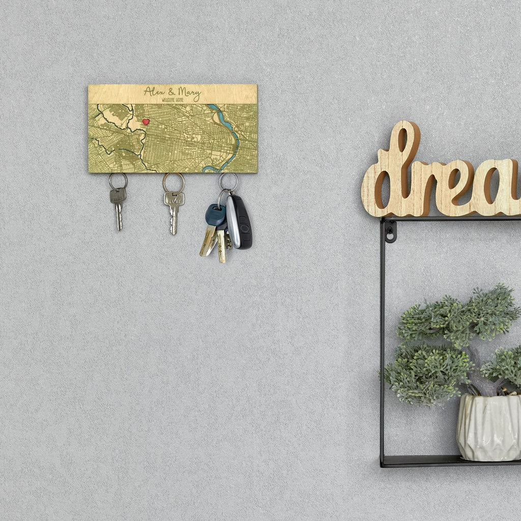 Wooden key rack for wall with custom home map displayed in entryway next to decor shelf