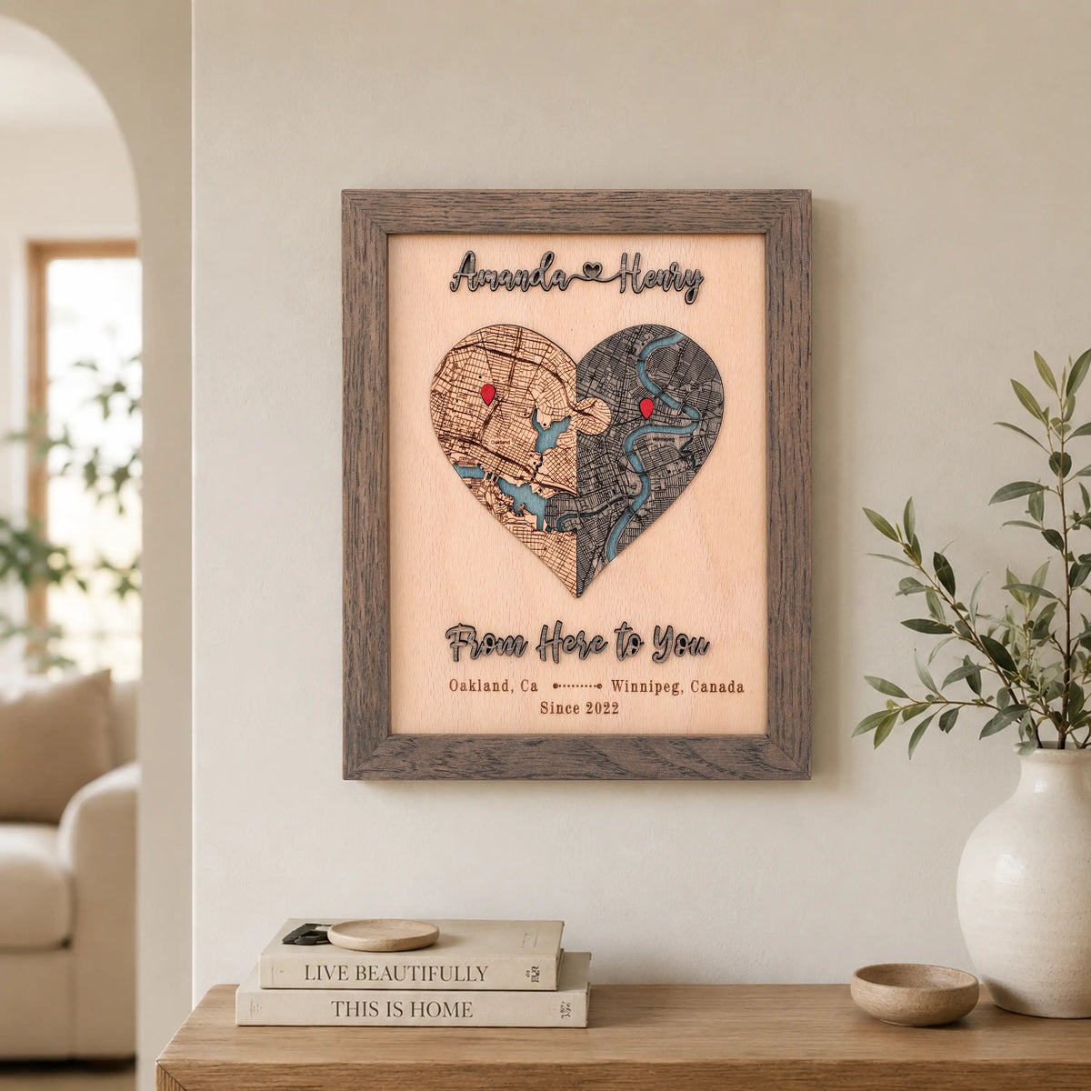 Wooden love story map wall decor in grey frame with custom two-location heart map and personalized 3D text.