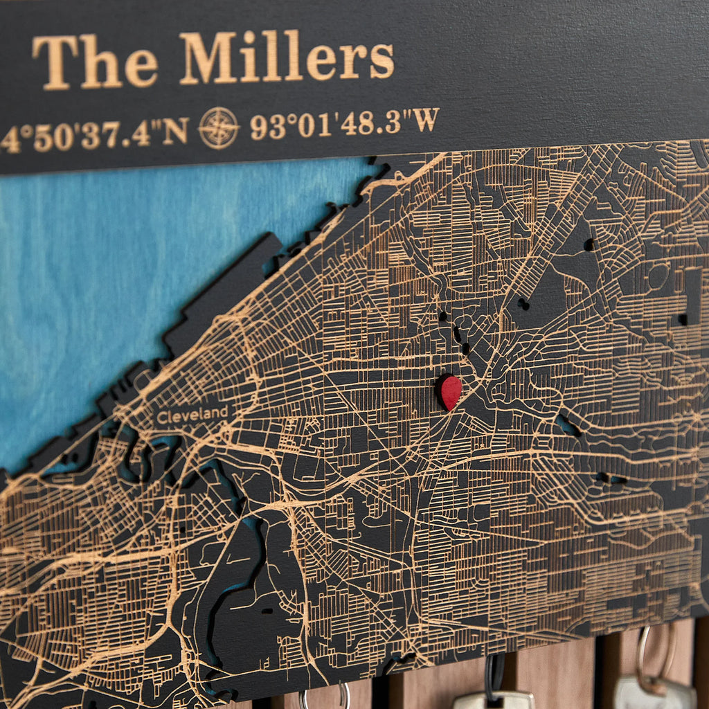 Close-up of black wooden magnetic key holder with custom coordinates and red location pin