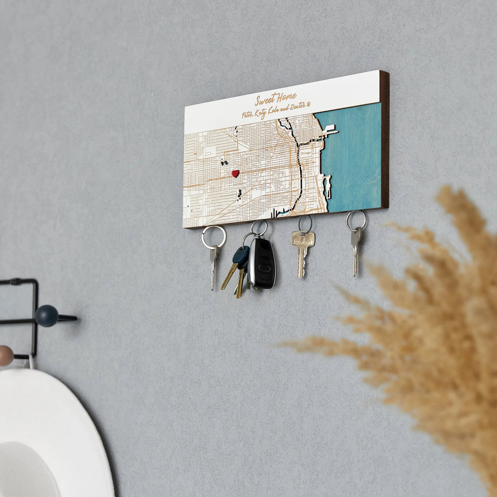 Wooden magnetic key holder for wall with custom coordinates shown in white finish and angled lifestyle view