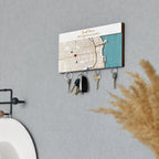 Wooden magnetic key holder for wall with custom coordinates shown in white finish and angled lifestyle view