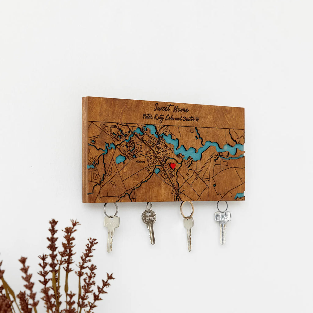 Wooden wall key holder with personalized map design displayed on wall with keys